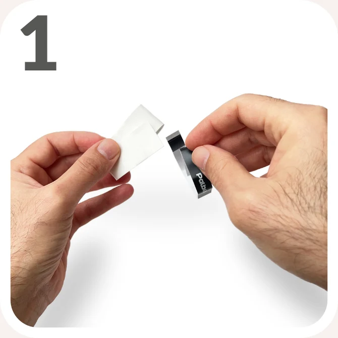 Step 1 — Remove the black adhesive tape around the overgrip and set it aside.
