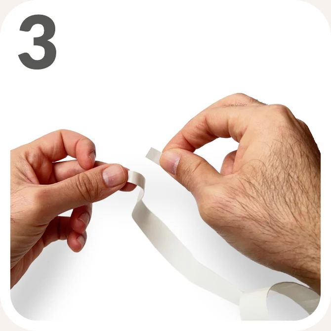 Step 3 — Remove the small adhesive tab at the narrower end of the overgrip.